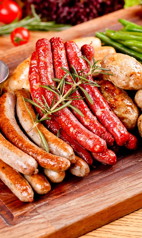 Tradycyjne polskie kiełbasy podane na drewnianej desce z dodatkami